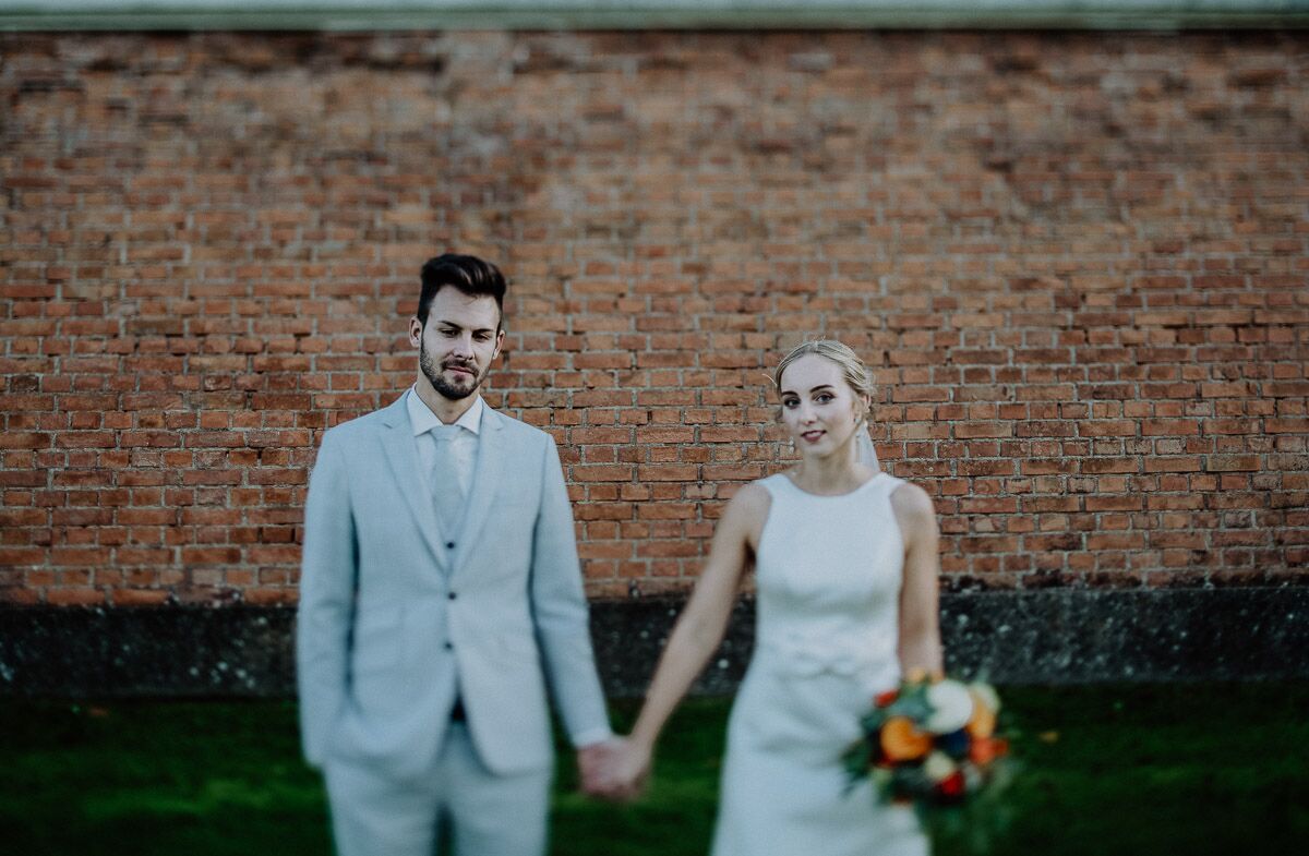 Brautpaar steht vor Schloss Hof und umarmt sich beim Sonnenuntergang After-Wedding-Shooting
